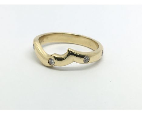 An unusual gold eternity ring set with eight diamonds, approx 3.5g and approx size K.