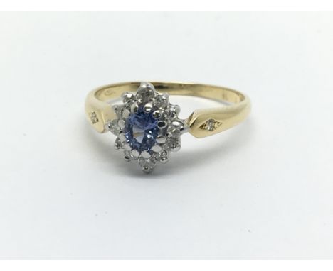 An unmarked gold ring set with a central Ceylon sapphire and surrounded by diamonds, approx 2.4g and approx size L-M.