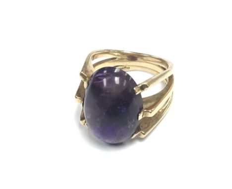 A 14carat 585 modern design gold ring set with amethyst cabochon 9.5g approximately. Ring size N