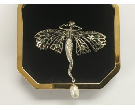 A silver brooch of an Art Nouveau female figure with plique-a-jour enamel decoration and a suspended pearl, approx 5.5 cm.