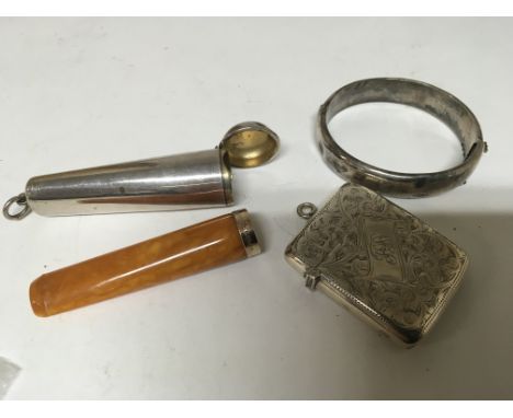 An Amber and gold banded cigar cheroot holder in a silver case a silver bangle and a silver Vesta case Chester hallmarks (3)