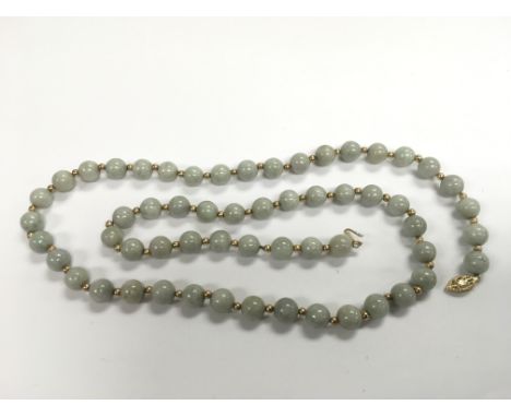 A pale jade necklace with 14k gold clasp.