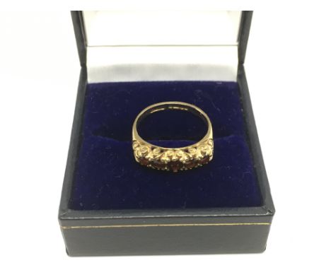 A 9ct gold ring set with five garnets, approx 2.1g and approx size L-M.
