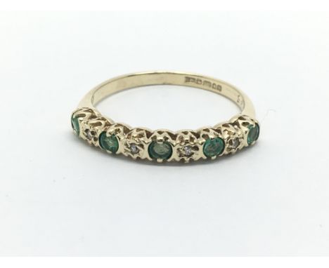 A 9ct gold half eternity ring set with alternating emeralds and diamonds, approx 1.3g and approx size J-K.