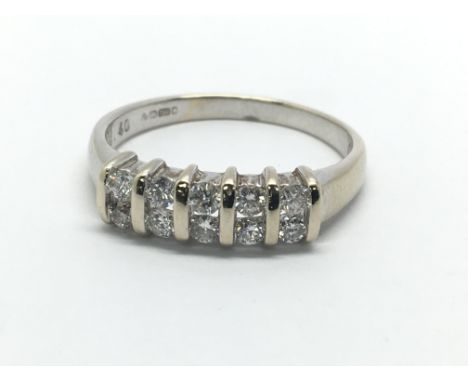 An 18ct white gold ring set with two rows of diamonds, approx.65ct, approx 3.5g and approx size P.