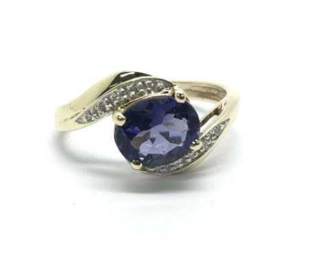 A 9ct gold ring set with a central tanzanite and surrounded by diamonds, approx 2.5g and approx size L.