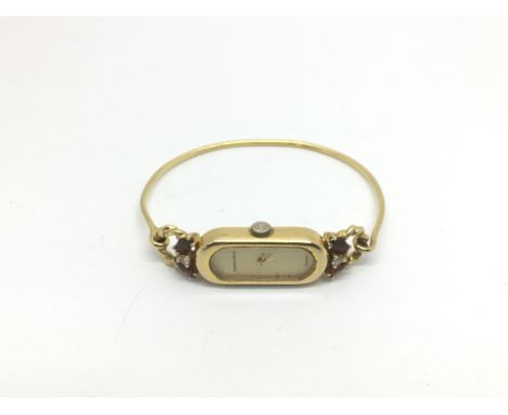 A Bueche Girod 9ct gold bangle watch set with diamonds and rubies, approx total weight 14g.