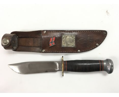 Scouting interest - A Marbles Gladstone, hunting knife In A leather sheath with mounted with 1949 World Rover Moot tin badge,