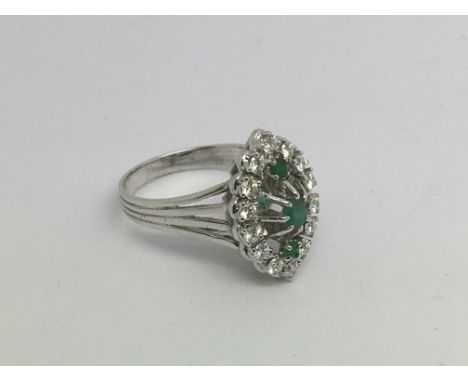 An 18ct white gold, diamond and emerald marquis shape cluster ring, approx 5.9g and approx size N.