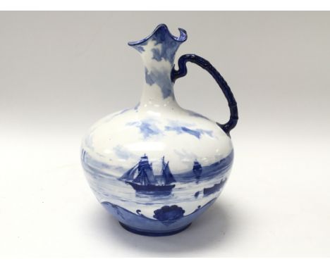 A Royal Crown Derby jug decorated in a blue and white ship scene by W.E.J. Dean