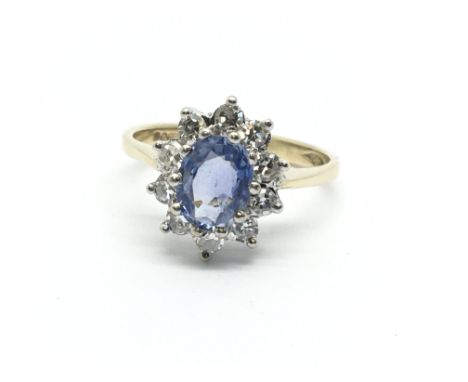 A 9ct gold ring set with a central sapphire and surrounded by ten diamonds, approx 1/2ct, approx 2.2g and approx size I-J.