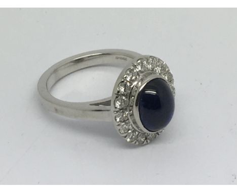 An 18ct white gold diamond and cabuchon sapphire cluster ring, approx 8.9g and approx size O.