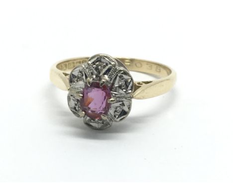 An 18ct gold ruby and diamond cluster ring, approx 3.1g and approx size N.