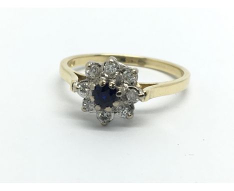 An 18ct gold sapphire and diamond cluster ring in the form of a flowerhead, approx 2.5g and approx size K.