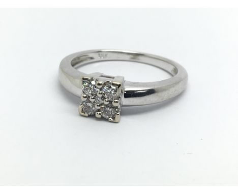 An 18ct white gold ring set with four diamonds, approx.25ct, approx 3.7g and approx size L.