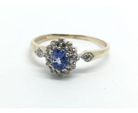 A 9ct gold ring set with a central Ceylon sapphire surrounded by diamonds, approx 1.8g and approx size Q-R.