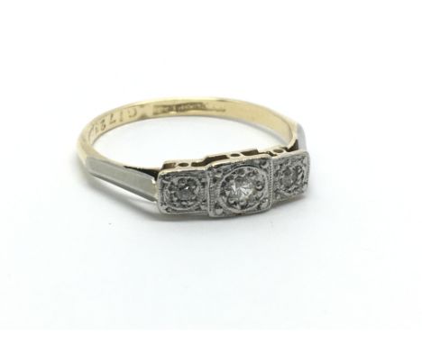 An 18ct gold and platinum three stone diamond ring, approx 2.7g and approx size Q.