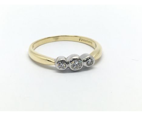 An 18ct gold three stone diamond ring, approx .15ct, approx 2.6g and approx size M-N.