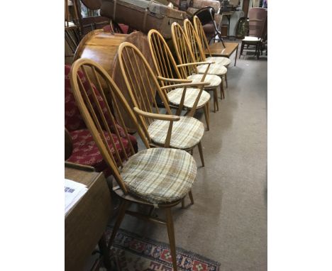 Six light wood  Ercol dining chairs comprising two carvers and four others.