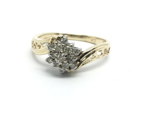 A 14ct gold diamond cluster ring in the form of a flowerhead, approx 3g and approx size L-M.