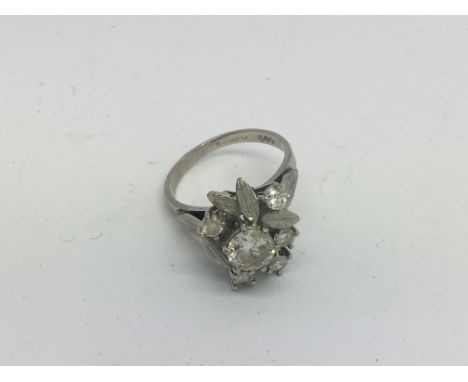 An 18ct white gold floral design diamond cluster ring, centre stone approx 1ct with 5 surrounding stones approx 0.15ct each, 