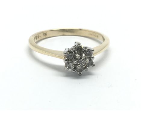 A 9ct gold seven stone diamond ring in the form of a flowerhead, approx .25ct, approx 2g and approx size M-N.