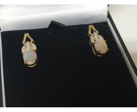 A pair of opal doublet and chip stone diamond  earrings in a fitted box.