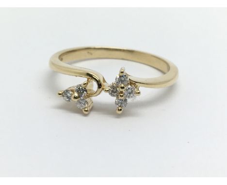 An 18ct gold seven stone flower design diamond ring, approx 2.3g and approx size L.