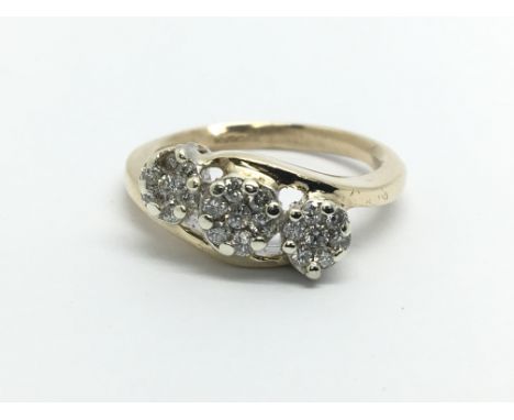 A 9ct gold ring set with diamonds in the form of three flowerheads, approx.33ct, approx 4.1g and approx size N.