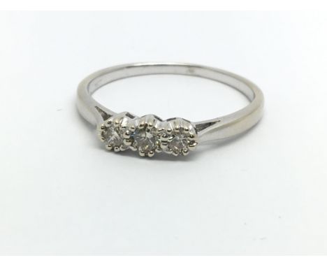 An 18ct white gold three stone diamond ring, approx.20ct, approx 2.6g and approx size S.