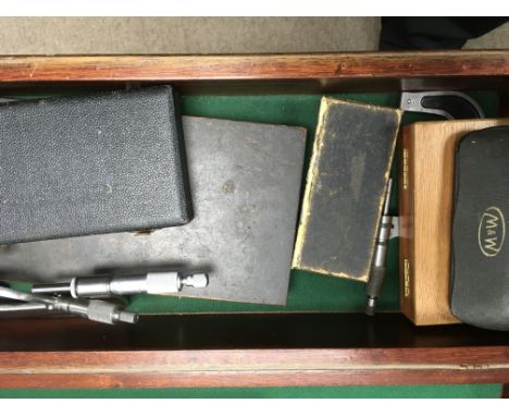 A collection of precision tools a box of nuts and empty tool chests ,