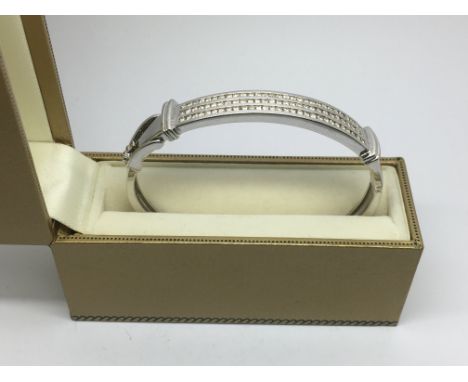 A 9ct white gold diamond set bangle, approx 20g.