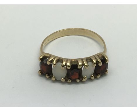 A 9ct gold, opal and garnet ring, approx 2.6g and approx size P-Q.