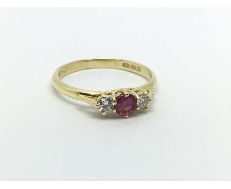 An 18ct gold ring set with a central ruby and a diamond either side, approx 1.6g and approx size H-I.