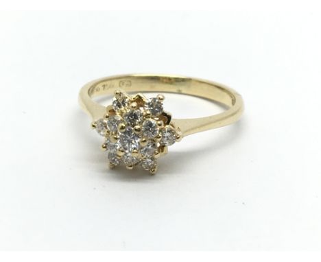 An 18ct gold diamond cluster ring in the form of a flowerhead, approx .33ct, approx 2.5g and approx size K.