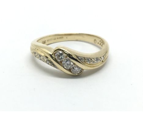 An 18ct gold three stone diamond ring with further diamonds to the shoulders, approx 2.7g and approx size J-K.