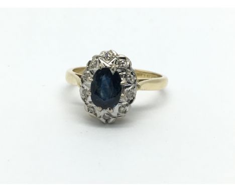 An 18ct gold sapphire and diamond cluster ring, approx 3.4g and approx size J-K.