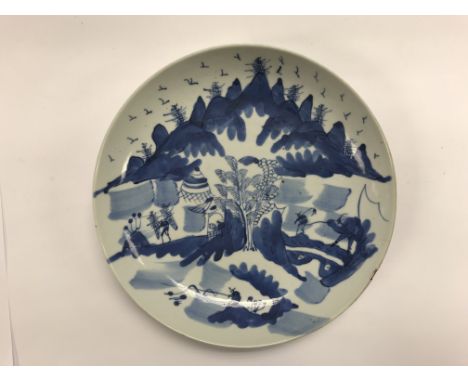 An early Blue and white Chinese porcelain plate with hand painted landscape.