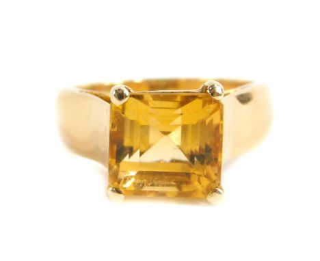 A high-set design citrine set solitaire dress ring, set with single square cut citrine in a four claw raised basket setting, 