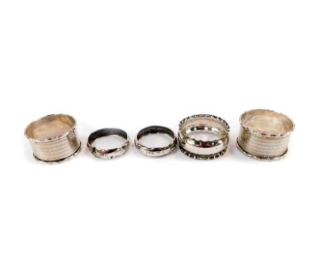 A pair of George V silver napkin rings, with engine turned decoration, Birmingham 1930, further pair of silver napkin rings, 