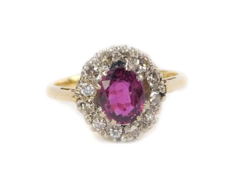 An 18ct gold ruby and diamond ring, in an oval setting, size G, 3.0g.