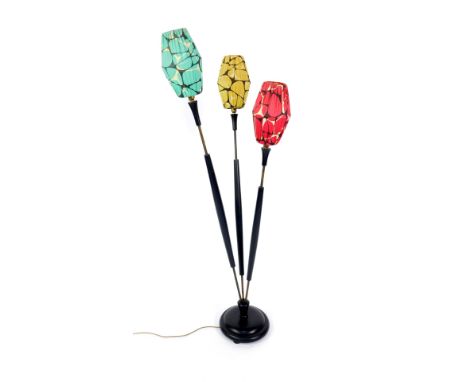 A 1950's ebonised and brass three branch standard lamp, the graduated branches with varied coloured marble patterned shades, 