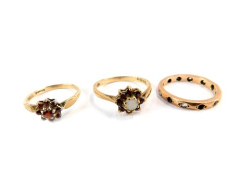 Three 9ct gold dress rings, comprising two floral clusters, one set purely with garnets, the other set with garnets and imita