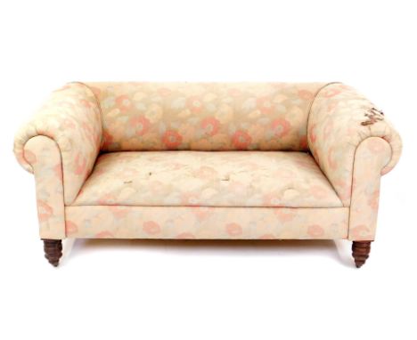 A Victorian mahogany Chesterfield sofa, with pink floral upholstery, raised on turned legs, brass capped on castors, 163cm W.