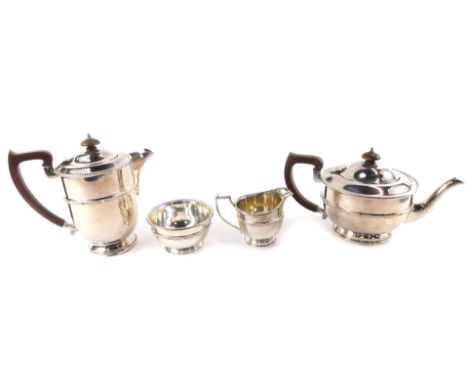 An Adie Brothers Ltd silver plated four piece tea set, decorated with a Celtic band, comprising tea pot, lidded hot water jug