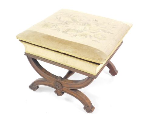 A Victorian rosewood box stool, the top with floral tapestry, raised on X framed supports united by a turned stretcher on cas