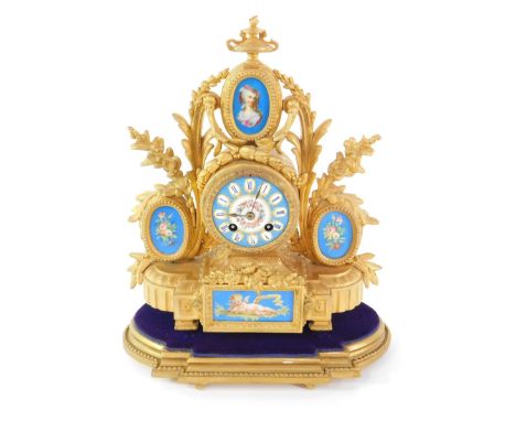 A late 19thC French ormolu and porcelain mantel clock, the circular dial bearing Roman numerals, painted with flowers and jew