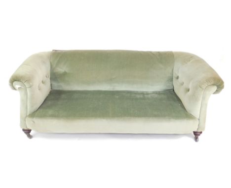 A Victorian mahogany Chesterfield sofa, upholstered in green draylon, raised on turned legs, brass capped on castors, 195cm W