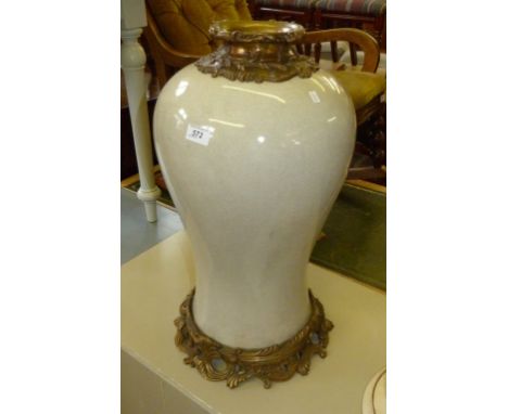 A contemporary large size ceramic crackle glazed floor vase having gilt metal mounts.