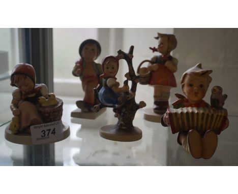 A collection of five Goebel Hummel ceramic figures to include a boy playing a accordion and a girl holding a basket.